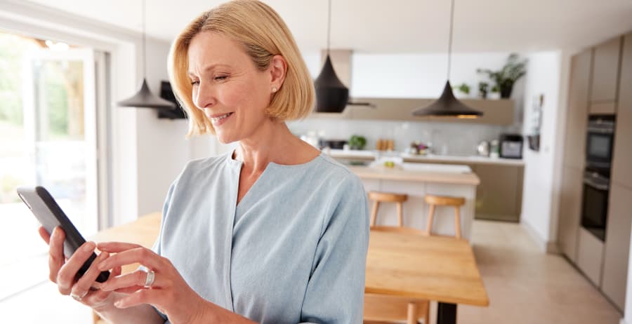 Resident with cell phone in a stylish home